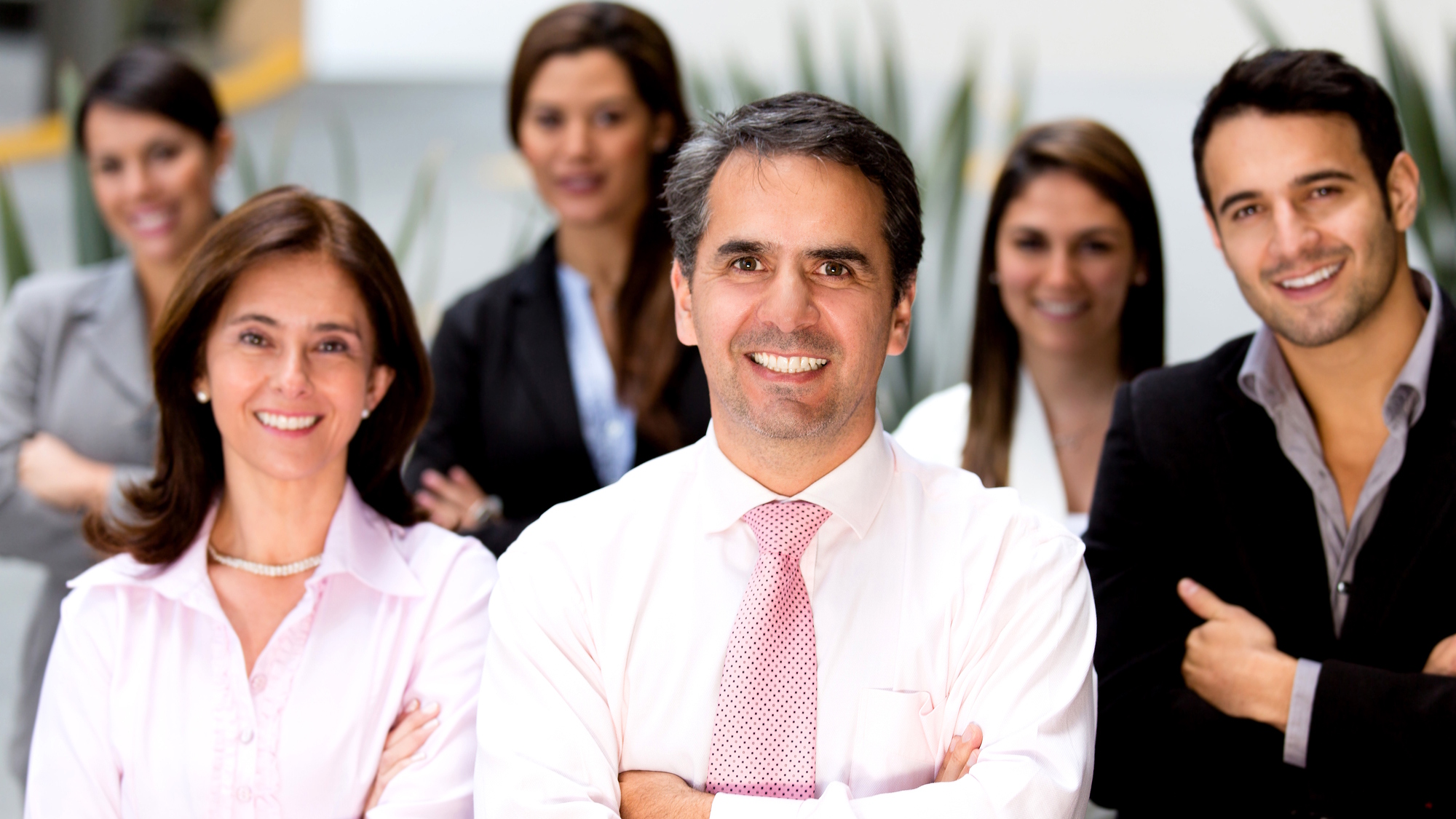 Couple sitting together on couch looking at laptop